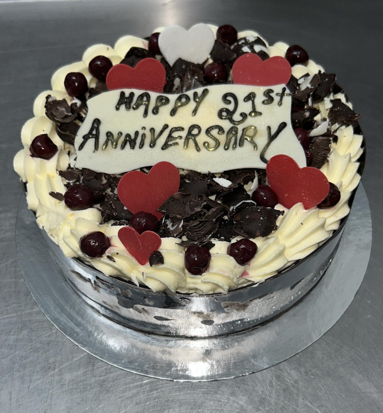 Black Forest anniversary cake with hearts and cherries