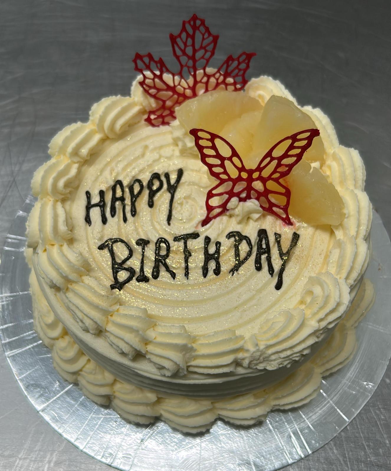 Happy Birthday pineapple cream cake with red leaf sugar art