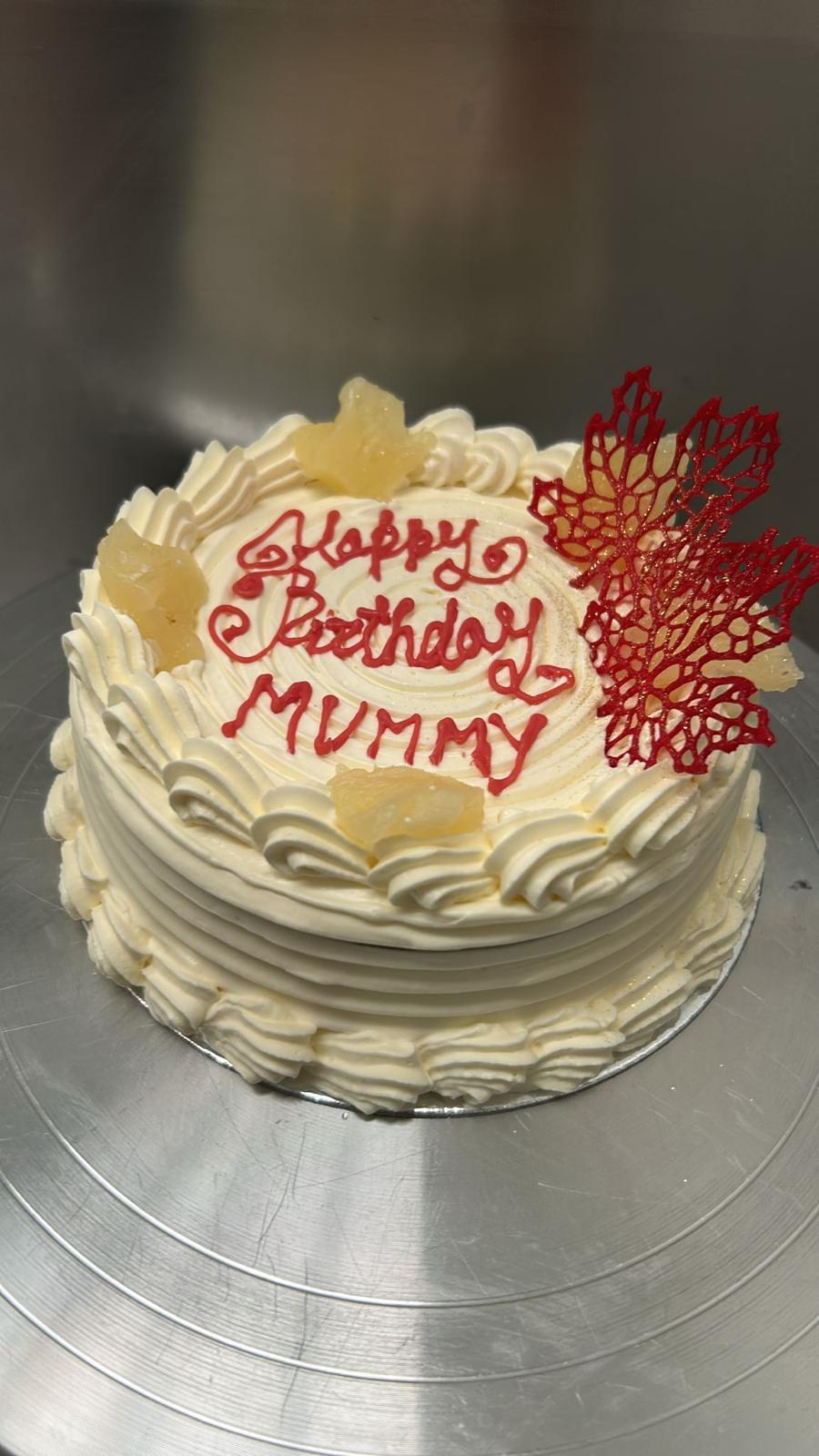 Birthday cake with red piped writing and pineapple cream frosting