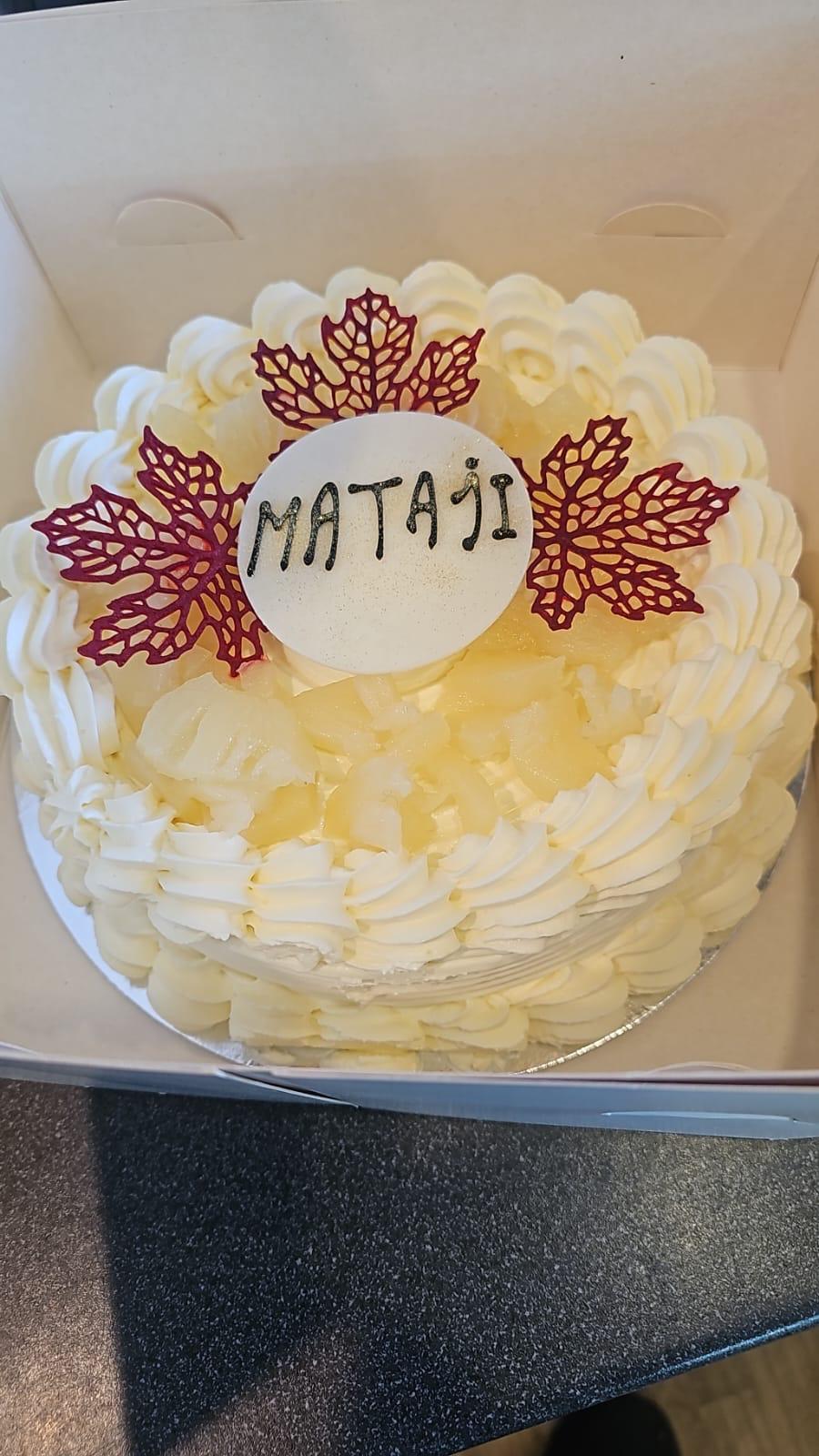 Pineapple cream celebration cake with red maple leaf decorations by Pastryology